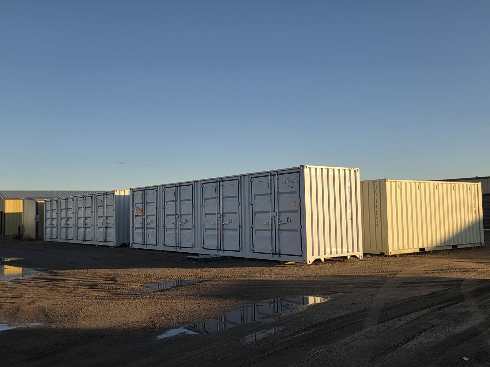 White seacans on a gravel lot